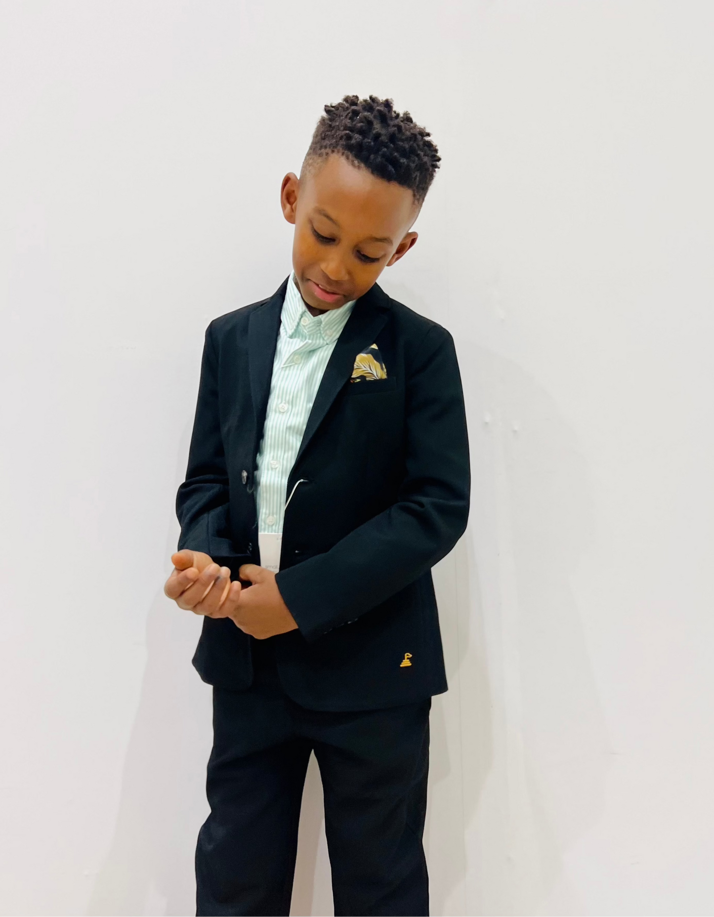 Black formal blazer over green pinstripe shirt