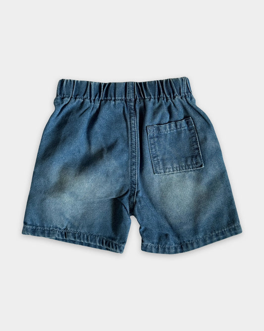 Blue denim shorts on a light gray background