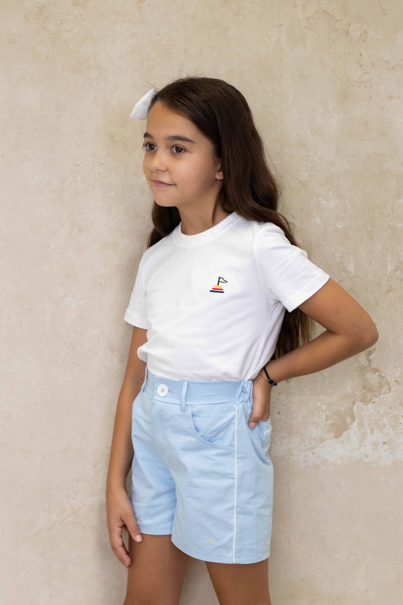 7Y toddler girl wearing our 8Y Alice shorts paired with our small land unisex white tee