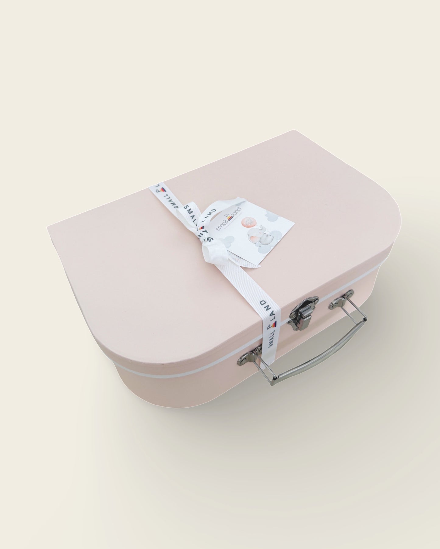 side view of pink suitcase gift box with ribbon and gift card