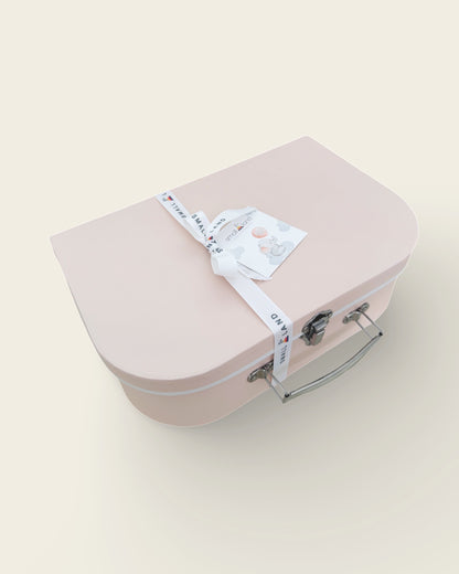 side view of pink suitcase gift box with ribbon and gift card