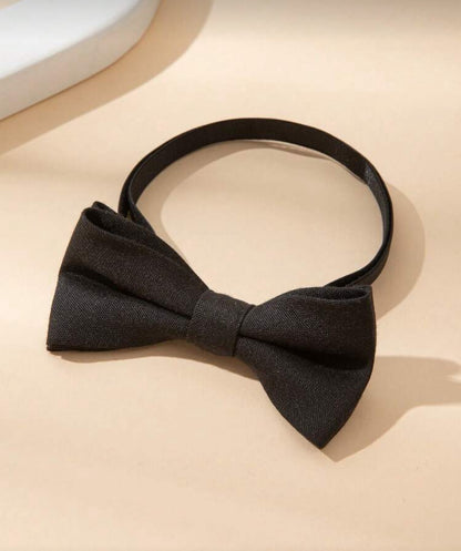 Black bow tie on a beige surface