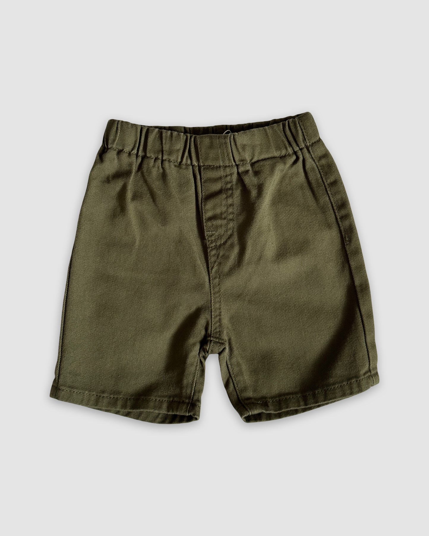 Khaki Green shorts on a light gray background