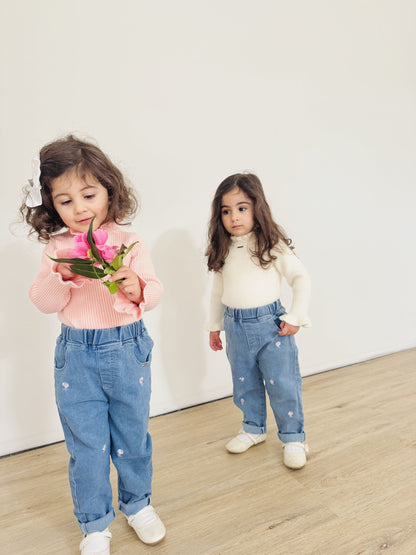 Toddler girls wearing the Gigi long sleeve winter knit in pink and white paired with our  toddler girl high waist denim Jean