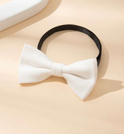 White linen bow tie against a beige background