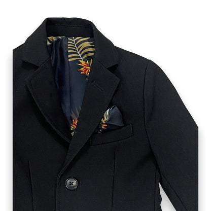 Black coat with a floral pocket square on a white background