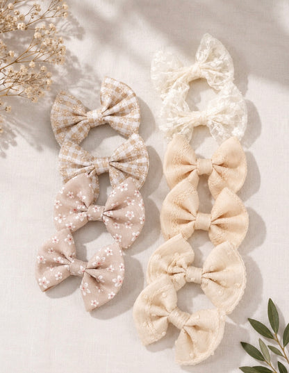 Mini bow hair clips that come in 2 packs. White/ Beige tones 