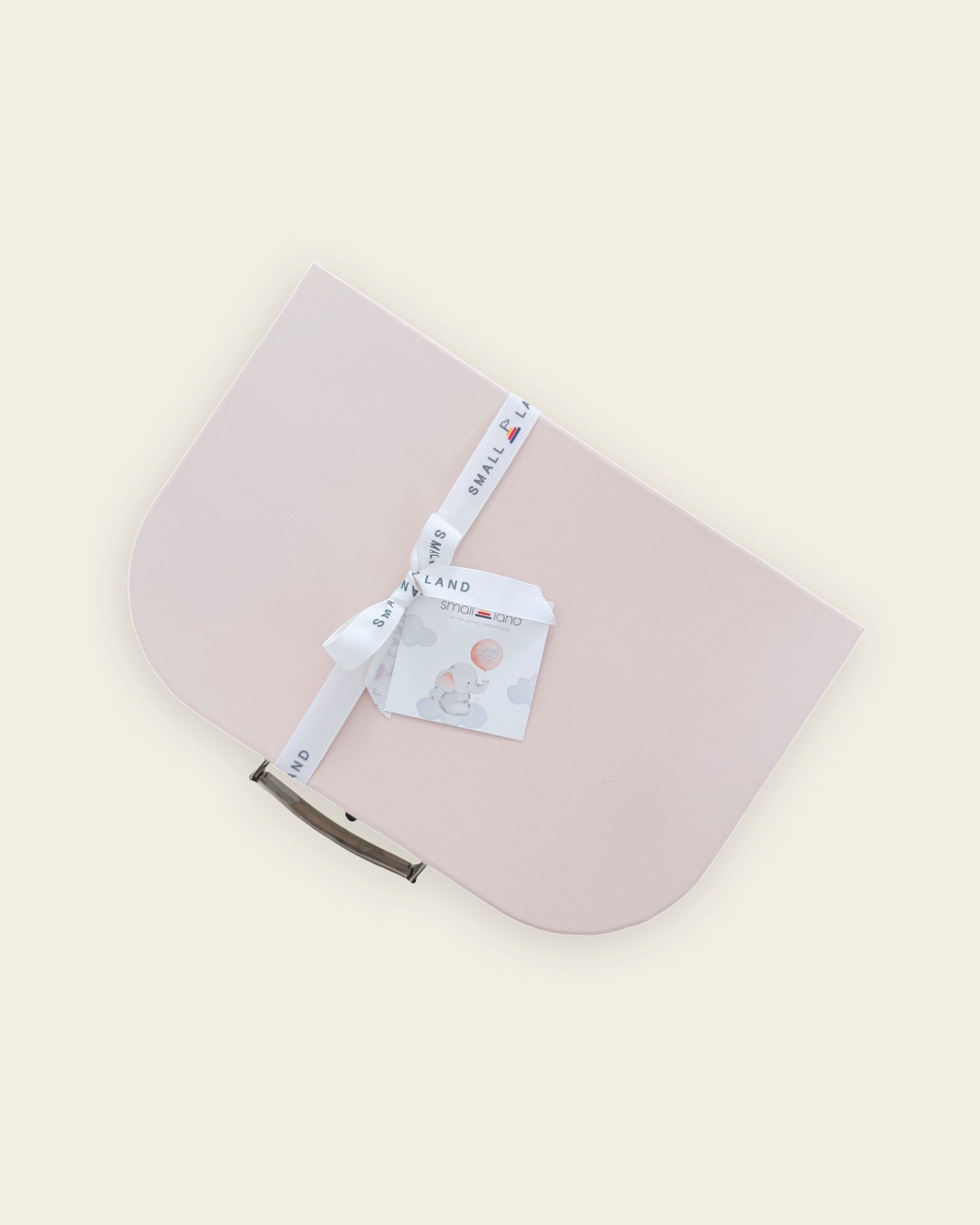 top view of pink suitcase gift box with ribbon and gift card