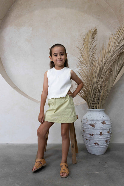 4Y model wearing ribbed cream tank top with lime green zara skirt